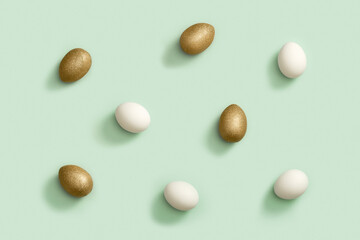 Decorated Easter golden and white eggs on green background. Happy Easter pattern.