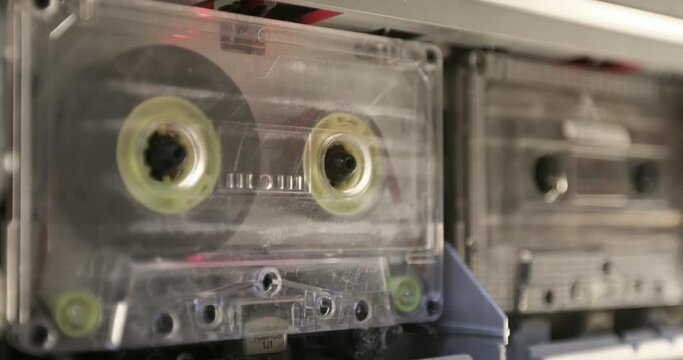 Vintage cassettes tape player . Audio cassette in the tape recorder playing and rotates. 