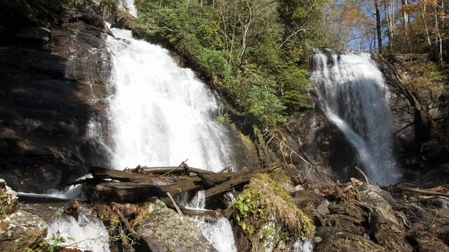 Water cascades down Anna Ruby Falls on autumn day, wide, slow motion