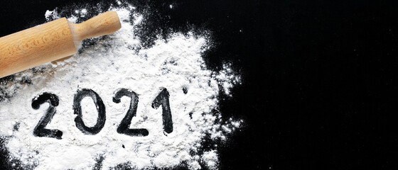 Preparation for cooking home made cookie. Baking flour and 2021 on black board. Top view, flat lay...
