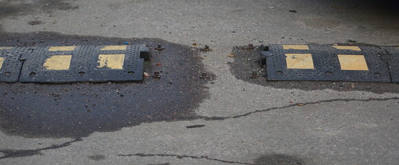 Fototapeta premium Broken speed bump on asphalt road