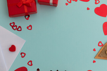 High angle view of red presents and hearts on blue background