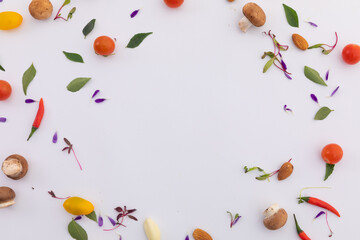 Fresh vegetables and leaves arranged in circle on white background