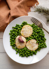 Sliced hake with peas