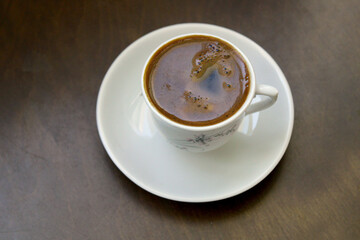 Cup of coffee on the table, top view