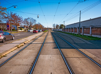 ramrod straigth tram tracks along the Viennese central cemetery, Austria