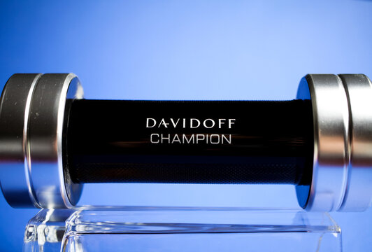 Viersen, Germany - May 9. 2020: Close up of isolated Davidoff champion men perfume flacon in shape of dumbbell on glass, blue background
