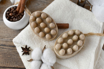 Fototapeta na wymiar Spa aromatherapy composition with natural soap bars, coffee beans, spicies and towel on wooden background. Body care, wellness and relax concept. Trendy color image for hygge style.