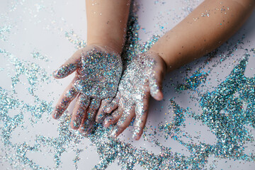 small children's hands in glitter sequins . Christmas new year holidays.