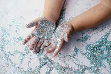 small children's hands in glitter sequins . Christmas new year holidays.