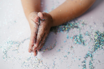 small children's hands in glitter sequins . Christmas new year holidays.