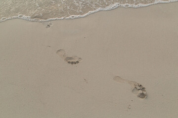 Foot Prints in Sand being Washed Away by Ocean