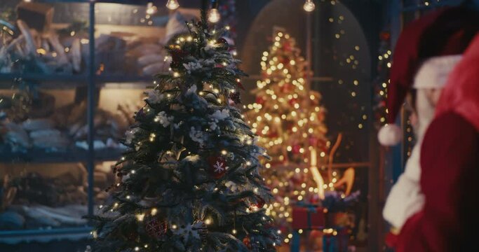 Santa Claus with presents walking near Christmas tree