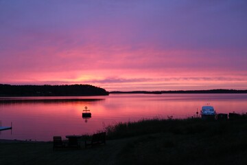 Gorgeous view of red cloudy sky during sunset on lake in Sweden.  Beautiful nature backgrounds.