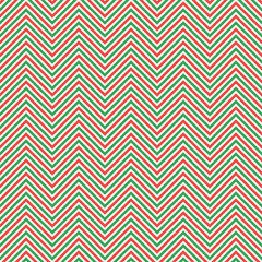 Geometric christmas seamless pattern of red and green zigzags. Vector illustration on a white background.