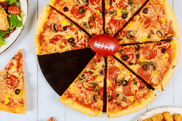 Delicious supreme pizza for american football game party.