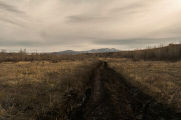 Beautiful autumn landscape in the steppe. Country dirt road. Dramatic landscape. Ust-Kamenogorsk outskirts, kazakhstan
