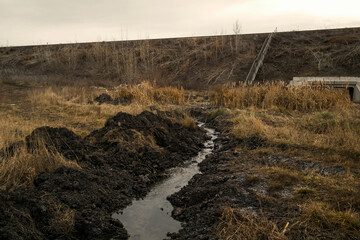 Railway mound. Concrete staircase and tunnel. Autumn landscape. Ditch. Steppe. Grunge nature