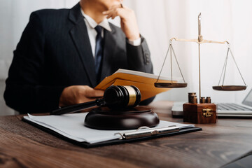 justice and law concept.Male judge in a courtroom on wooden table and Counselor or Male lawyer...