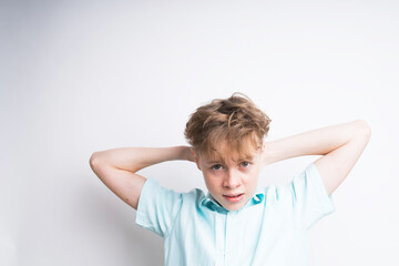 Cute Caucasian boy stretching his arms on a white background