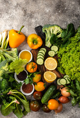 Fresh vegetables Greens and cereals with chopping board on the table