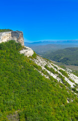 Fototapeta na wymiar Picturesque mountain valley immersed in the greenery of the forest in Crimea near the city of Bakhchisarai 