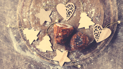 Chocolate cake and wooden Christmas figures, top view