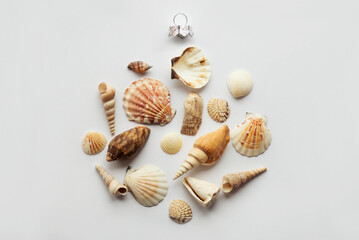 Christmas in July. Christmas flat lay with sea shells on white background