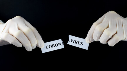 Hands tearing paper with word Coronavirus Coronavirus elimination concept COVID-19 pandemic is over.