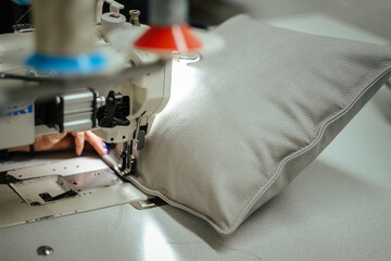 Closeup shot of a sewing machine making a pillow