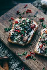 Sandwiches with mushrooms on a cutting board on a wooden background. Large photo..