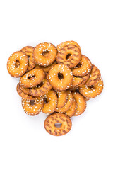 Pile of salty round pretzel pieces isolated over white