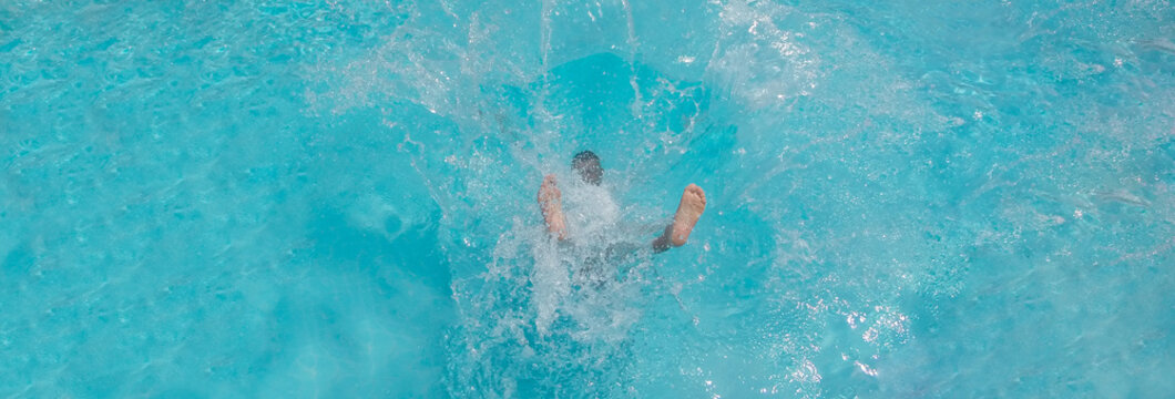 Man Falling And Splashing Into Blue Water