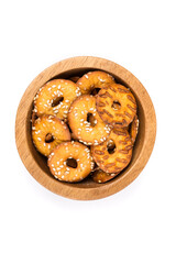 Salty round pretzel pieces in a bowl isolated over white
