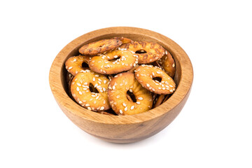 Salty round pretzel pieces in a bowl isolated over white