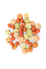Pile of green red and orange oriental snack mix isolated over white top down view