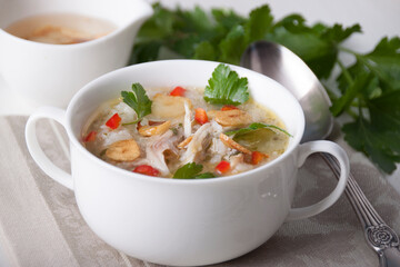 Chicken soup with rice and garlic chips and chili
