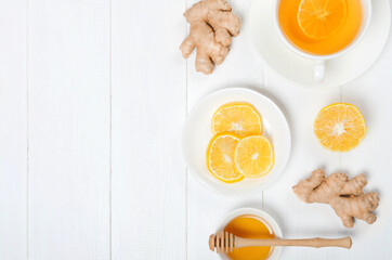 Ginger with lemonand herbal tea on white wooden backgroundbackground