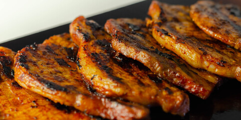 Fresh and juicy pork loin steaks,  grilled meats on the wooden board - 395797963