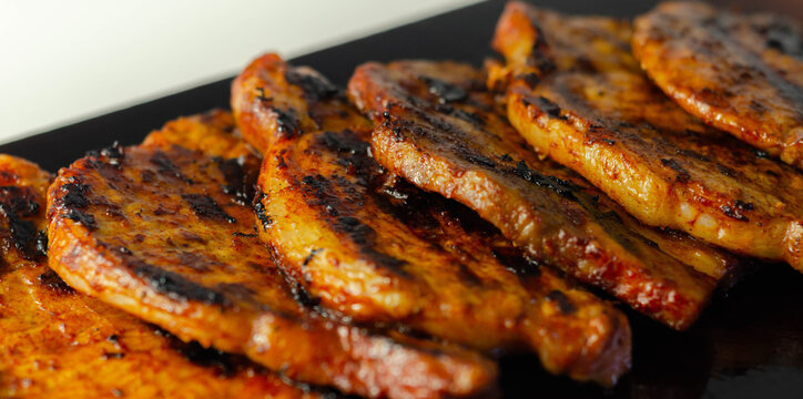 Fresh and juicy pork loin steaks,  grilled meats on the wooden board
