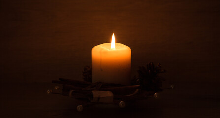 Christmas candles burning at night. candle and fire - a symbol of memory and continuation of life. Banner. FOCUS ON THE CANDLE