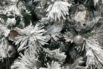 Close-up of Christmas tree decoration with white, silver and bronze shades. Christmas and New Year decorated interior