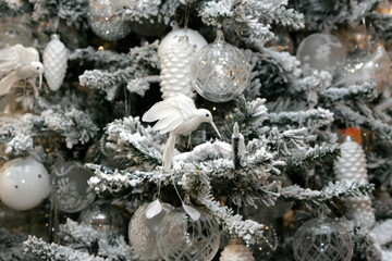 Close-up of Christmas tree decoration with white, silver and bronze shades. Christmas and New Year decorated interior