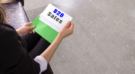 Businesswoman sitting with green envelope hold letter with massage b2b sales