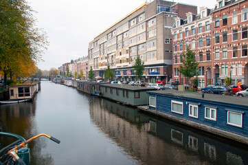 Canal view. A row of houses on the water along the canal. Residential houses on the water