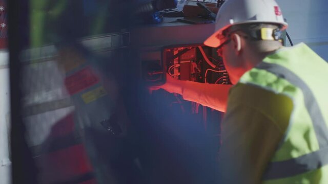 Engineer checks broken industrial robot cabinet