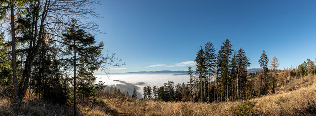 panoramic view ground fog in valley, seen from mountain Pleschkogel near village Rein in Styria, Austria