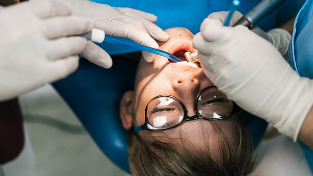 Young Boy In Dentist With Open Mouth