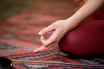 Detail of hands while meditation. woman practicing yoga concept natural balance between body and mental development.