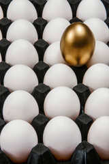 Golden egg in the middle of other eggs